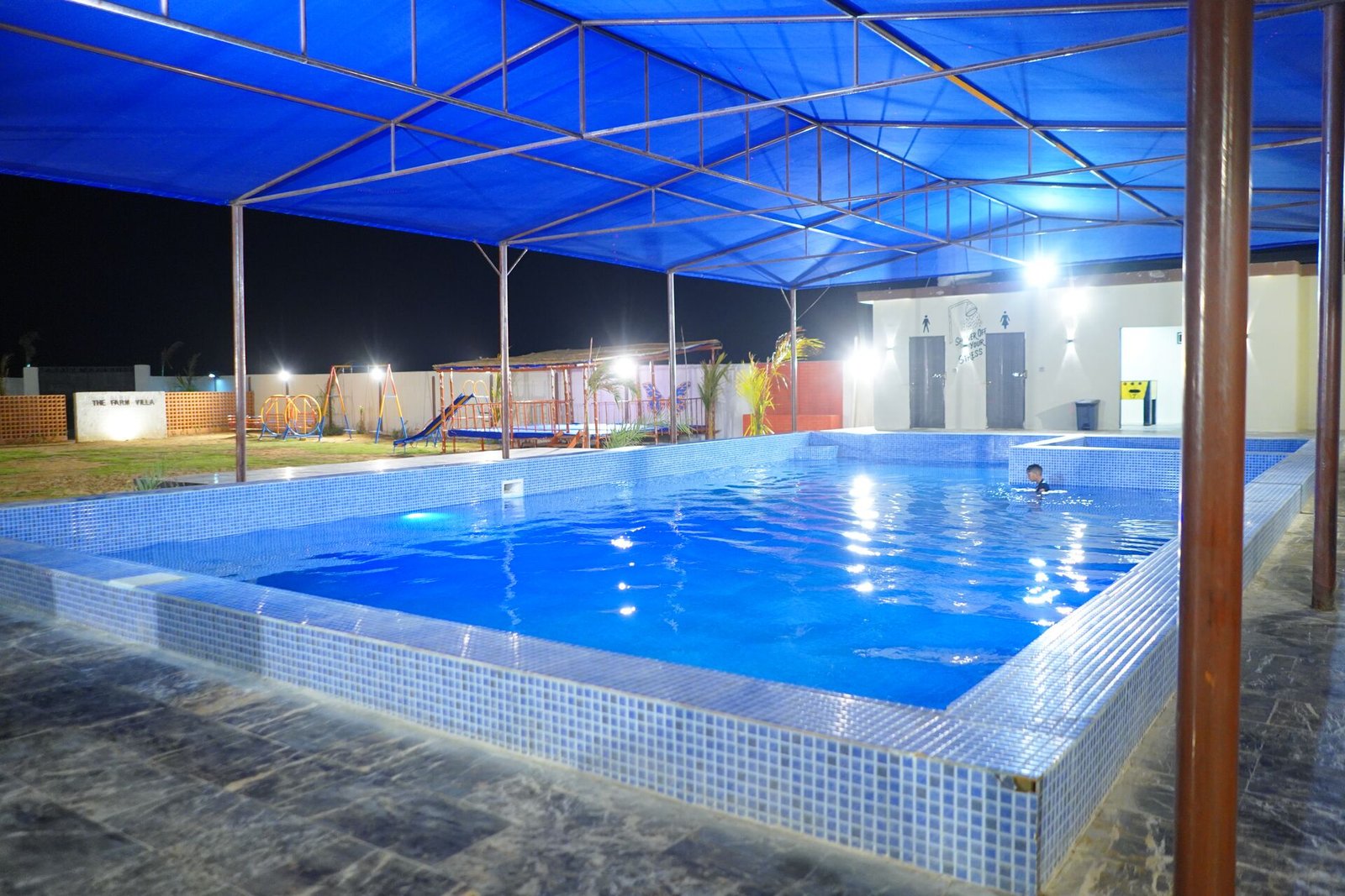 Night view of blue swimming pool